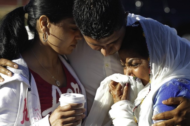 Amardeep Kaleka, son of the president of the Sikh Temple of Wisconsin, comforts temple members on Aug. 6.