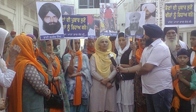 Sikh Women Displaying Pictures of Singhs Lodged in Jails Throughout India