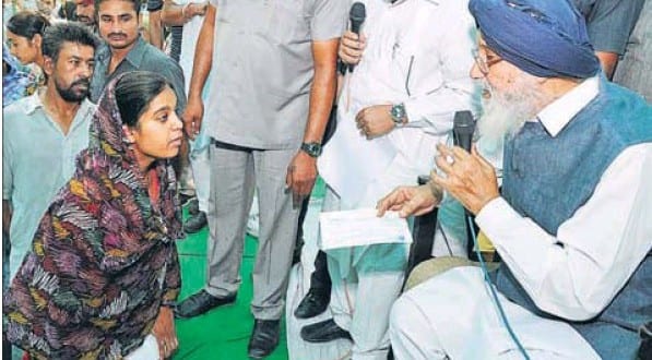 Punjab Chief Minister Parkash Badal listening to the grievance of a woman in a gathering at Talwandi Sabo.