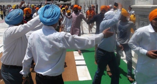 Police men stopping Sikh youth