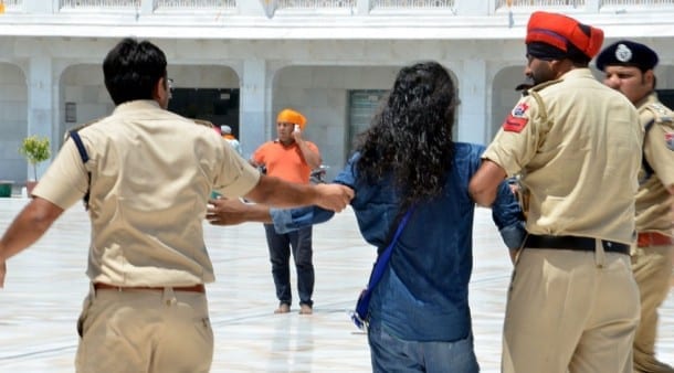 Police arresting the Sikh youth