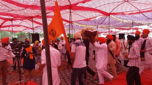 Singhs Bringing holy Bir of Guru Granth Sahib in Samgam with honour