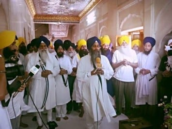 Sikh sangat performing Ardas on the eve.