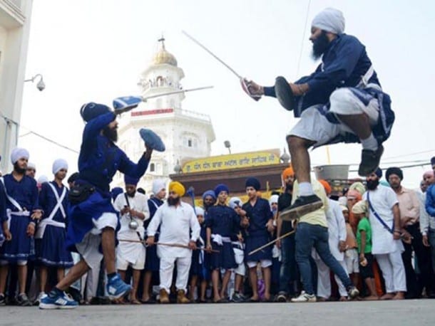 Sikh boys showing their skills during a 'nagar kirtan' outside the Golden Temple in Amritsar on 411th installation anniversary. 