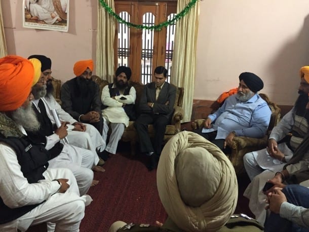 Akali Dal's spokesperson Dr. Daljeet Singh Cheema and Deputy Commissioner Rajat Aggarwal talking with the Singhs present in Bapu Ji's home.