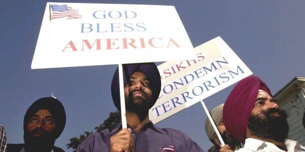 395648 07: Sikh men carry patriotic placards at a community service to remember victims of terrorist attacks, October 10, 2001 in Santa Ana, CA.Although Sikhs are not Muslims and come from India, they have been targeted in recent hate crimes because the men wear turbans and beards similar to terrorist suspect Osama bin Laden. (Photo by David McNew/Getty Images) | David McNew via Getty Images