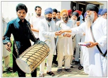 Baba Hardeep Singh distributes sweets to villagers 