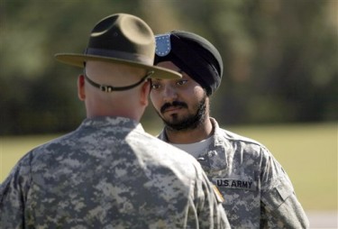U.S. Army Corporal Simran Lamba, right, speaks to his drill sergeant following his graduation from basic combat training at Fort Jackson, S.C., Wednesday, Nov. 10, 2010. 