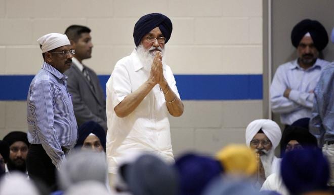Journal Sentinel files - Punjab Chief Minister Parkash Singh Badal, gestures to the crowd as he prepares to speak at the visitation services held for the six Sikh shooting victims.