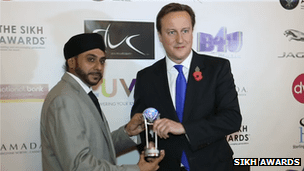 David Cameron was given his prize by Navdeep Singh, who founded the awards 