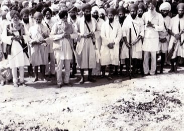 Panthic leaders, including Baba Jarnail Singh Bhinderanwale, Bhai Joginder Singh Talwara, Bhai Amrik Singh at the site where the Antim-Saskar of the 13th Shaheeds was performed. Bhai Fauja Singh Ji's shield can be seen amongst the ashes