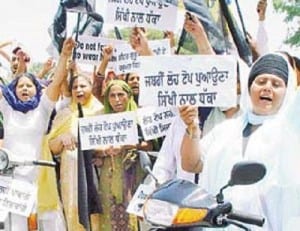 A File photo of Sikh women protesting against compulsory helmet rule