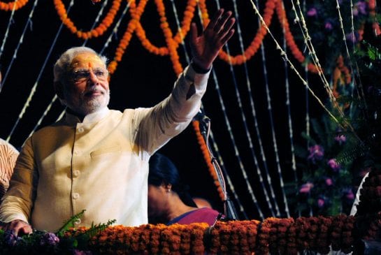 Indian Prime Minister-elect Narendra Modi waves to supporters after performing a religious ritual at the banks of the River Ganges in Varanasi 
