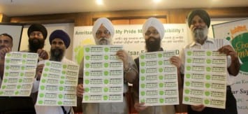 Representatives of EcoAmritsar release sticker inscribed the awareness slogans
